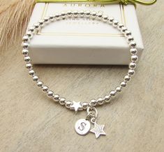 Sterling silver beaded stretch bracelet with a star and initial charm. Makes s a lovely gift for someone. Your Bracelet Details: - 925 sterling silver beads - sterling silver star bead - sterling silver initial charm The beads are 4mm. Finished on strong elastic thread " one size " which will fit up to 7 inches. Select your initial at checkout. Your bracelet will arrive in a gift box, and bow. A design by Silver Aurora Studio. Thank you. * Please read shop policy before ordering * Items in the U Silver Beaded Bracelets With Star Charm, Silver Beaded Bracelet With Star Charm And Round Beads, Star-shaped Letter Beads Bracelets As Gift, Star-shaped Letter Beads Bracelets For Gift, Star-shaped Letter Beads Bracelet As Gift, Star Shaped Letter Beads Bracelets For Gifts, Silver Beaded Bracelets With Star Charm As Gift, Silver Beaded Bracelet With Star Charm As Gift, Silver Beaded Bracelet With Star Charm For Gift