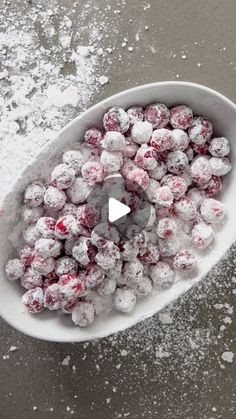 a white bowl filled with powdered sugar and sprinkles on top of a table