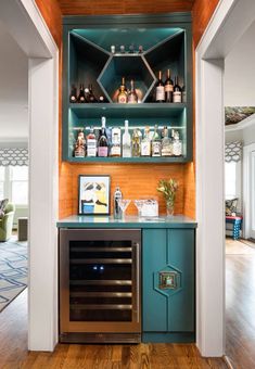 an open cabinet with liquor bottles on it