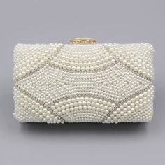 The Violeta Luxury Pearl Clutch Bag has a stunning and luxurious look. This bag is made of high-quality materials and has enough space for your essentials while still looking elegant at the same time. Its embroidered exterior bespeaks its beauty, while its exquisite frame demonstrates luxury. Exclusively available in c Luxury Clutch With Pearl Handle For Reception, Luxury Rectangular Cosmetic Bag For Formal Occasions, Luxury Rectangular Cosmetic Bag For Formal Use, Elegant Beige Rectangular Evening Bag, Glamorous Beige Rectangular Bag, Luxury Pearl Embellished Clutch Bag, Elegant Beige Clutch Evening Bag, Elegant Beige Clutch For Gift, Elegant Beige Clutch As Gift