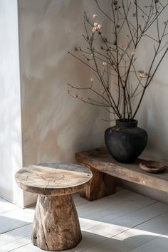 a wooden bench sitting next to a potted plant