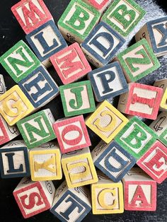 colorful wooden blocks with letters spelling out the word abc and p are stacked on top of each other