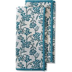 two teal and white floral napkins on a white background, one with blue trim