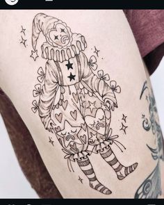 a woman with a tattoo on her thigh holding a teddy bear and wearing a santa hat