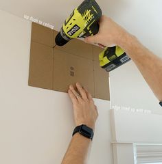 a man is using a drill to fix a box with a screwdriver on it