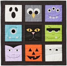 a quilted wall hanging with different faces and eyes on it's face,