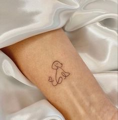 a small dog tattoo on the ankle