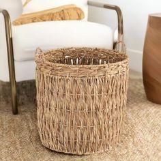 a wicker basket sitting on the floor next to a chair