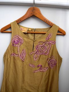 A beautiful vintage dress from the early 200s. Made from greenish brown raw silk, with pink flower embellishments to the front. Key-hole detail to the neckline, zip to the back. Made by Jackpot Very good vintage condition with no signs of age or wear. Marked as a Size 1 Chest: 35/ 90cm Waist: 30"/ 76cm Hips: 37"/ 94cm Length: 42"/ 107cm Flower Embellishments, Pink Midi, Key Hole, Embellished Dress, Raw Silk, Vintage Dress, Dress Clothes For Women, Pink Flower, Aging Signs