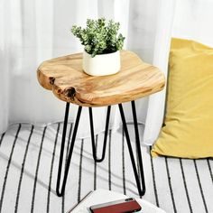 a small table with a phone on it and a potted plant next to it