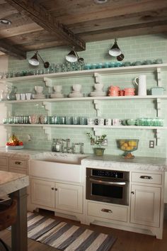 a kitchen filled with lots of open shelves