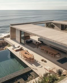 an aerial view of a house overlooking the ocean