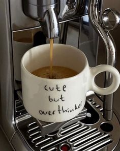 a cup of coffee is being filled with something that says cute but overthik