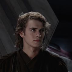 a young man with long hair wearing a star wars outfit and looking at the camera