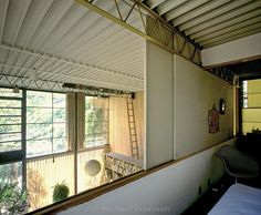 a bedroom with a ladder hanging from the ceiling