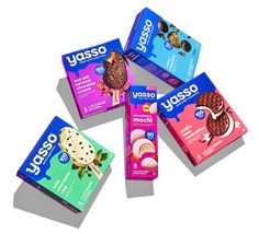 four boxes of yusso ice cream sitting on top of each other in front of a white background