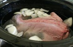 the meat is being cooked in the slow cooker