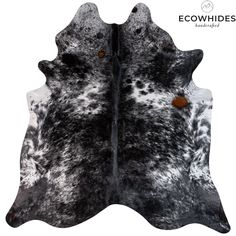 two pieces of black and white cowhide with brown spots on it's back