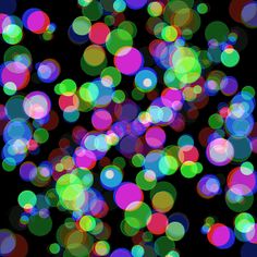 an image of colorful lights on a black background with lots of blurry circles in the middle