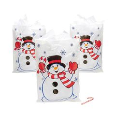 two bags with snowmen on them and one has a candy cane in front of it