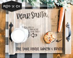 a wooden sign that says dear santa with cookies and carrots next to it on a table