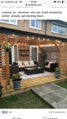 an outdoor living area with couches and lights on the roof, in front of a house