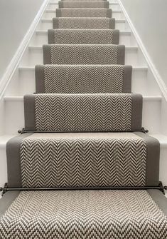 a set of stairs with carpeted treading and handrails