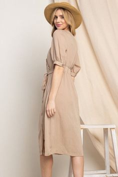 Elevate your wardrobe with our Asymmetrical Button-Down Wrapped Midi Dress, a true embodiment of timeless elegance and style. This dress offers a perfect blend of sophistication and modern flair, ensuring you'll look effortlessly chic and feel confident on any occasion. Key Features: Half-Sleeve Design: The dress features a half-sleeve with button closure, providing a touch of modesty and versatility. You can adjust the sleeves to your preference, making it suitable for various weather condition Fitted Midi Dress With Button Back, Solid Color High-low Hem Spring Dress, Elegant Beige Button-up Midi Dress, Fitted Knee-length Midi Dress With Button Back, Elegant Spring Dress With High-low Hem, Elegant High-low Hem Spring Dresses, Chic Solid Dresses With Button Cuffs, Spring Belted Dress With Asymmetrical Hem, Midi Length Button Back Dress For Daywear