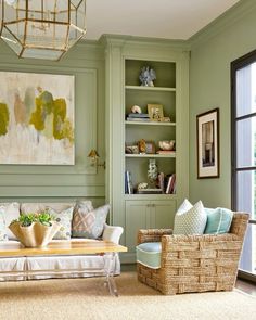 a living room with green walls and furniture