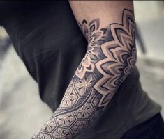 a person with a black and white tattoo on their arm