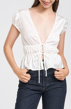 Dainty ties tether the front of this puff-sleeve top shaped by sweet smocking. Ties at front Deep V-neck Short sleeves 100% polyester Hand wash, dry flat Imported Tie Front Top, Front Tie Top, Puff Sleeve Top, Anniversary Sale, V Neck Tops, Baby Sets, Deep V Neck, Jean Coat, Accessories Design