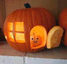 a pumpkin carved to look like a house with a hole in the front and inside