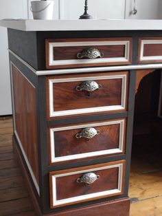 an old dresser has been painted black, white and brown with silver trimmings