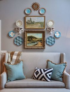 a living room filled with furniture and pictures on the wall