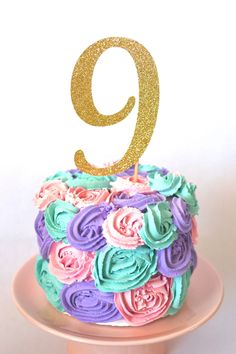 there is a cake that has the number nine on it and flowers all over it