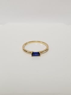 "Thanks for shopping our vintage estate store. We tend to sell well below wholesale and truly hope you enjoy all of our items. Many of the items are one of a kind, so please enjoy scrolling through the pictures and hopefully something will catch your eye. Brown spots are from reflections. Estate 14k yellow gold created .25ct sapphire ring.  Gem testing natural, but is created or synthetic.  Ring size: 7.75 Setting: 6.5mm 1/4\" by 3.5 1/8\" Band width: 1.5mm Weight: 1.71 grams Marked 14k and tested to be 14k gold." Blue Emerald Cut Stackable Jewelry, Classic Stackable Sapphire Ring, Classic Stackable Topaz Ring As Gift, Classic Stackable Topaz Ring Gift, Blue Stackable Rings With Emerald Cut, Blue Emerald Cut Stackable Rings, Classic Sapphire Jewelry With Baguette Cut, Blue Baguette Cut Birthstone Rings, Classic Emerald-cut Sapphire Birthstone Ring