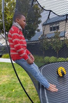 a man sitting on top of a trampoline