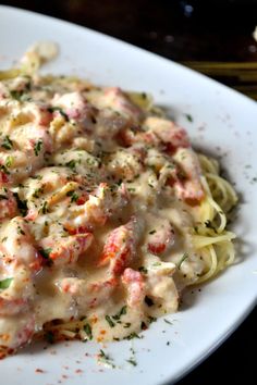 a white plate topped with pasta covered in sauce