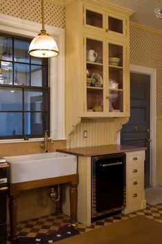 a kitchen with an oven, sink and cabinets in it's center island next to a window