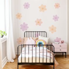 a bedroom with pink and yellow flowers painted on the wall