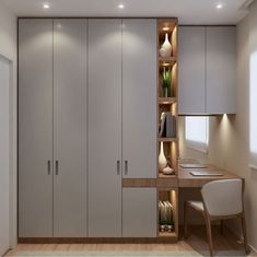 a room with white cupboards and lights on the wall next to a desk in front of a window