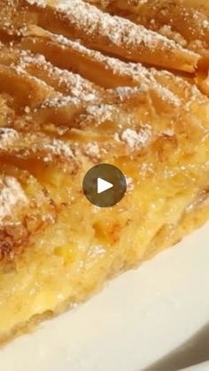 a piece of pie with powdered sugar on top is sitting on a white plate