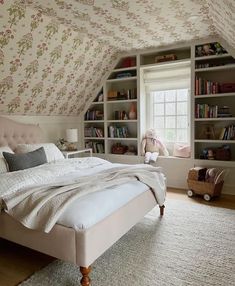 a bedroom with a bed, bookshelf and window in the ceiling is featured on instagram