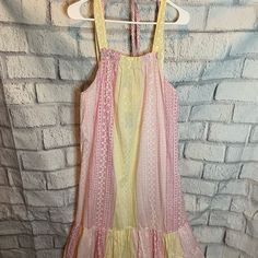 Pink And Yellow Tiered Skirt Midi Dress Sleeveless Tie At Back Size L Cotton Measurements: Length 46”, Armpit To Armpit 22” Yellow Maxi Sundress With Ruffles, Yellow Ruffled Maxi Sundress, Yellow Bohemian Sundress With Ruffles, Yellow Sleeveless Ruffled Midi Dress, Yellow Sleeveless Midi Dress With Ruffles, Yellow Sleeveless Dresses For Brunch, Yellow Sleeveless Casual Dress, Yellow Ruffled Midi Dress For Casual Wear, Yellow Sleeveless Midi Dress For Daywear