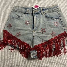 Mainstrip Denim Shorts With Red Fringe! Called The Shake It Shorts, Never Worn, Nwt, Bought From An Online Boutique.Best Fits A Medium But Could Probably Also Fit A Small, Stretchy Material