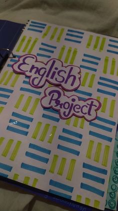 an english project binder on a bed next to a notebook with the words english project written in it