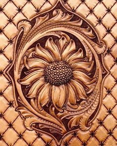 an intricately designed leather background with a sunflower