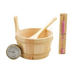 a wooden bucket with measuring tape, spoon and thermometer