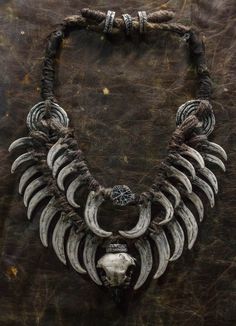 Crafted for the daring and unique, this neck jewelry embodies a fusion of Bohemian style and post-apocalyptic vibes. Perfect for shaman costumes, LARP products, and festival decorations, it features fangs and bird skulls for an edgy touch. This double necklace adorned with a ring necklace is a must-have for horror lovers looking to make a bold statement with their accessories. A distinctive piece that sets you apart from the crowd. ❗️DETALIS❗️ Our products are meticulously crafted by skilled art Shaman Costume, Larp Accessories, Medicine Seller, Bird Skulls, Post Apocalyptic Costume, Neck Jewelry, Double Necklace, Horror Lovers, Bone Jewelry