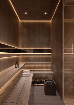 a bathroom with wooden walls and lighting on the ceiling